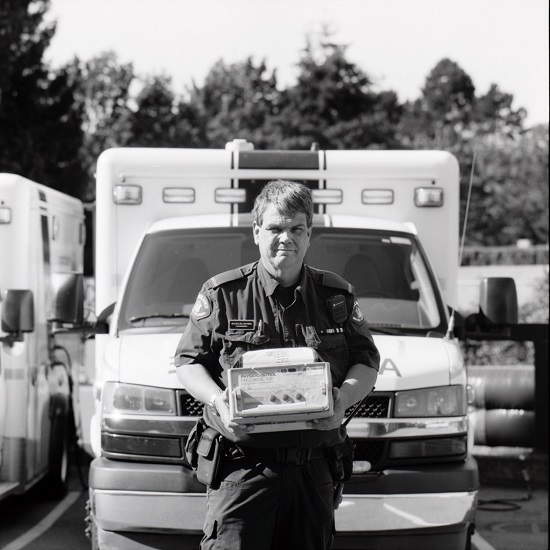 Michael Dussault holding a defibrillator