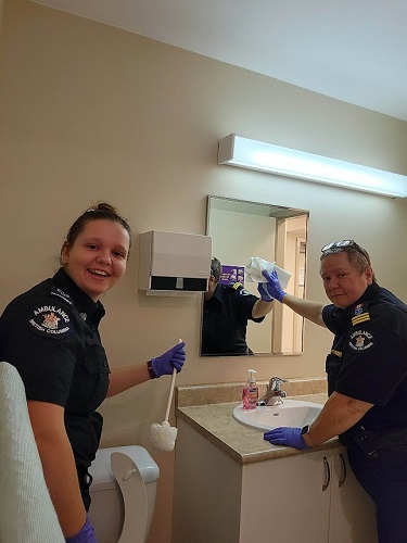 Paramedics Tina and Joy cleaning a washroom